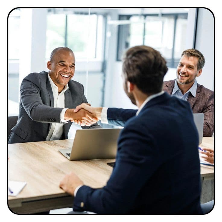 A Regainr team member greeting a client with a handshake